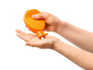 Woman applying sunscreen onto her hand against white background