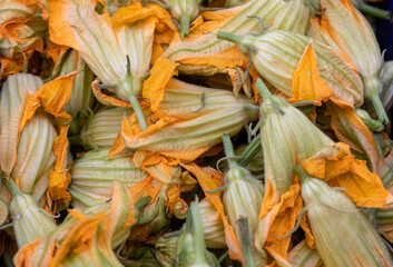 Fresh zucchini flowers at a farmers market in Italy