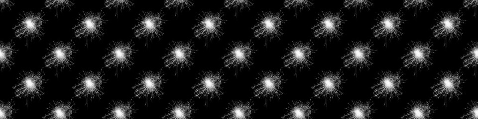 Seamless black and white pattern. Bright white fireworks, salute isolated on black background. Festive patern