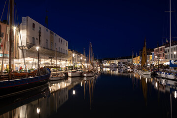 Fototapeta na wymiar Night view of the port canal designed by Leonardo da Vinci and old town of Cesenatico on the Adriatic sea coast
