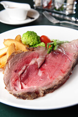 A Plate Of Roast Beef With Mixed Vegetables