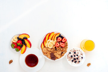 Summer breakfast with granola, croissant yoghurt and berries on a light background. Flatly.