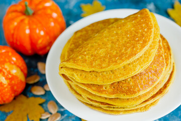 Pumpkin pancakes , stack of delicious pumpkin pancakes on white plate