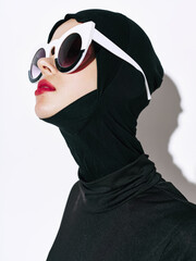 Black suit on woman with sunglasses red lips headdress 