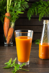 Natural carrot juice with pulp sugar-free in glasses on a wooden table