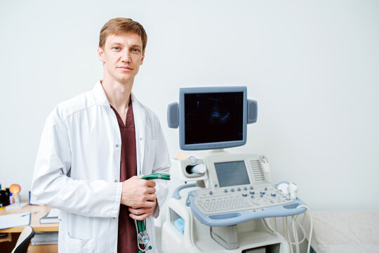 Portrait of good looking young doctor next to an ultrasound scanning machine
