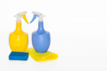 Plastic bottles with chemicals for home cleaning on a white background.