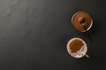 Alternative to coffee. Healthy drink chicory. Chicory coffee in a cup and powder in a bowl on a black background. Top view, copy space.