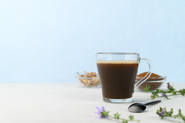 Alternative to coffee. Healthy drink chicory. Chicory coffee in a cup on a light gray table. space for text.