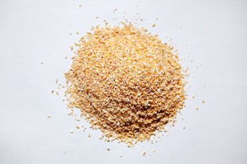 Wheat groats at white background . Heaps of wheat cereal for breakfast preparation