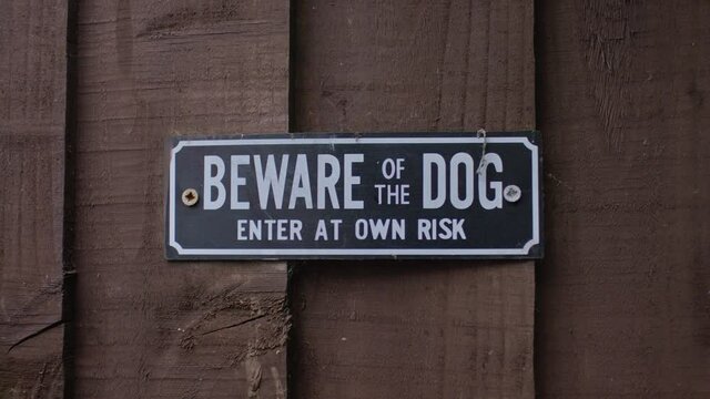 Beware of dog sign on a garden door