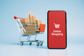 Concept online Sopping. boxes and shopping bag on Trolley with Smartphone Online Shopping screen.