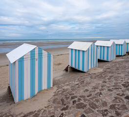 small striped beach huts in hardelot plage on the coast of normandy