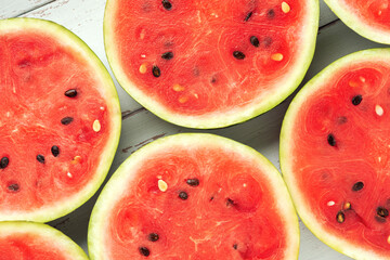 Close-up round slices of watermelon on white wooden Provence style table.