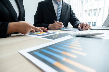 Two business leaders talk about charts, financial graphs showing results are analyzing and calculating planning strategies, business success building processes