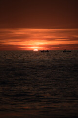 Fototapeta premium A vibrant and beautiful sunset and fisher man 
