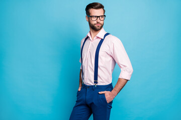 Photo of handsome macho business man cool clothes guy eyesight care vision specs look side empty space wear pink shirt suspenders pants isolated pastel blue color background