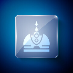 White King crown icon isolated on blue background. Square glass panels. Vector.