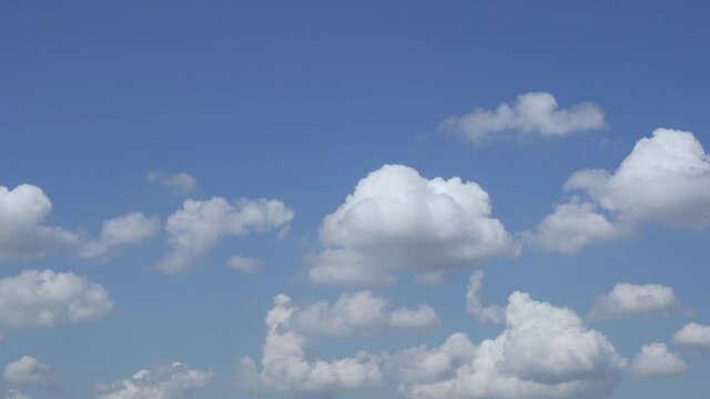White Fluffy Clouds in a Clear Blue Sky. Clouds and Sky 4k. Time Lapse Of Clouds During The Day.