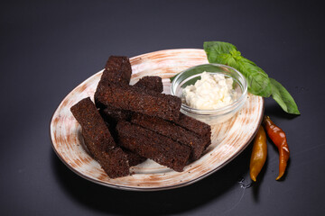 Black crouton with garlic sauce