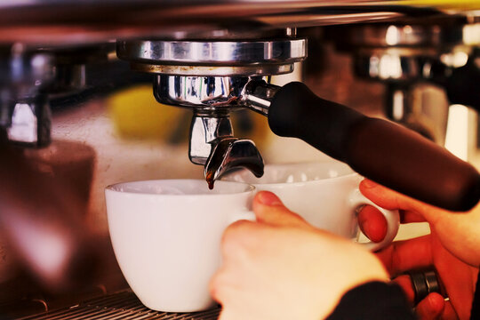 Making coffee in the coffee machine. Morning atmospheric lighting, fashionable trendy spot soft focus. Preparation for design creative menu.