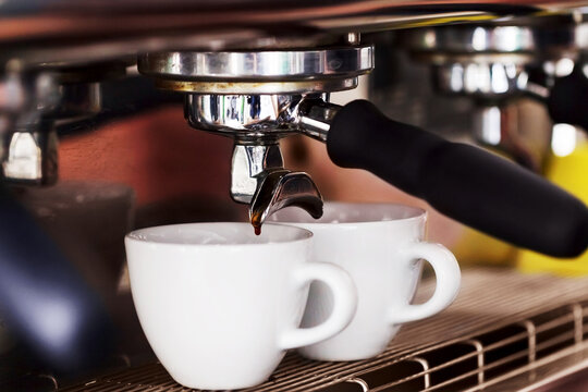Making coffee in the coffee machine. Morning atmospheric lighting, fashionable trendy spot soft focus. Preparation for design creative menu.