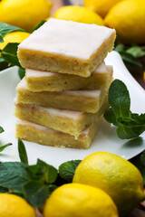 Authentic cake, lots of fresh yellow lemons and mint. Morning atmospheric lighting, trendy selective soft focus. Preparing to design creative menus.