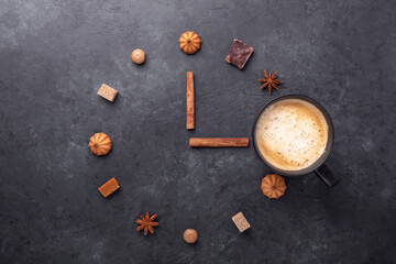 Coffee time. Cup of coffee and various sweets and spice on stone background. Top view. Copy space