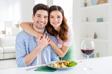 Obraz na płótnie Canvas Portrait of two nice attractive careful cheerful cheery spouses guy eating tasty yummy dish meal enjoying staying home leisure domestic restaurant in light white interior kitchen house apartment
