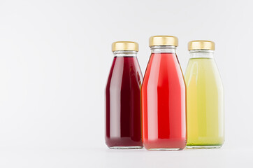 Red, pink, green fruit juices collection in glass bottles with cap mock up on white background, template for packaging, advertising, design product, branding.