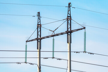 high-voltage power lines in a field on a summer day