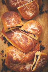 Tasty blueberry bun stuffed with fresh forrest fruits. Traditional polish bun called jagodzianka