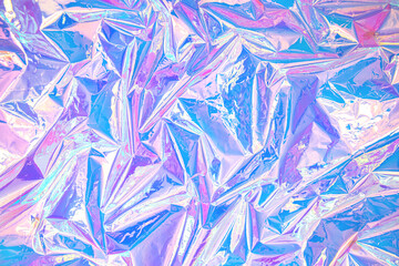 Blurred abstract Modern pastel colored holographic background in 80s style. Crumpled iridescent foil real texture. Synthwave. Vaporwave style. Retrowave, retro futurism, webpunk