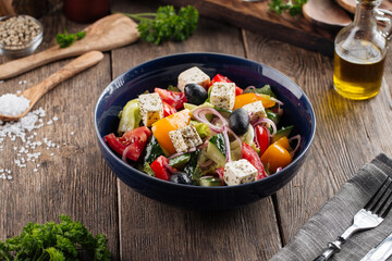 Closeup on fresh greek salad in a black bowl