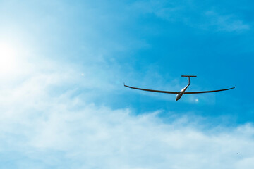 Glider plane flying at sunset