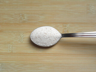 Fototapeta na wymiar White and pink color Himalayan rock salt powder on stainless steel spoon