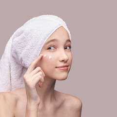 Young girl apply anti age cream. Skin care home routine. Sun protect cosmetic product. Copyspace....