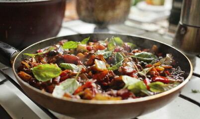 Healthy food vegetables are fried in a pan Tomato eggplant onion pepper zucchini