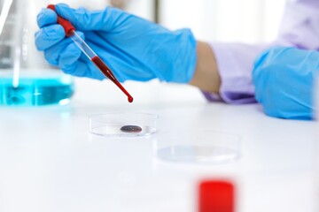 Scientist holding Coronavirus covid-19 infected blood sample tube DNA testing of the blood in the laboratory with blood sample collection tubes and syringe Coronavirus Covid-19 vaccine research.