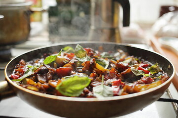 Healthy food vegetables are fried in a pan Tomato eggplant onion pepper zucchini