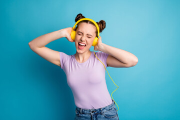Photo of cheerful youngster lady two buns good mood listen modern technology earphones excited...