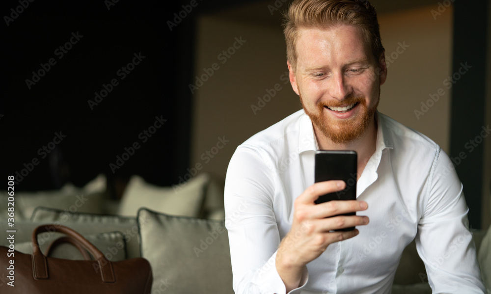 Sticker happy young man using his smart phone at office