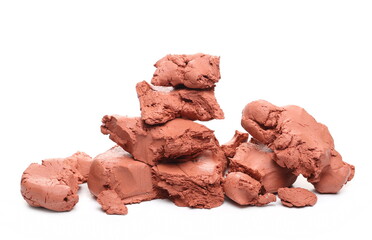 Red modelling clay chunks isolated on white background