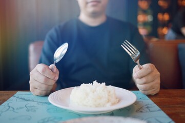 Man eating rice enjoying a meal in restaurant. man having dinner.