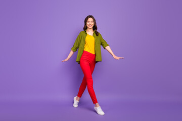 Fototapeta na wymiar Full length body size view of her she nice attractive pretty lovely cheerful cheery wavy-haired girl strolling isolated on bright vivid shine vibrant lilac violet purple color background