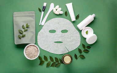 Fabric cosmetic face mask with set of cosmetics clay mask spatula and brush, moisturizing cream in...