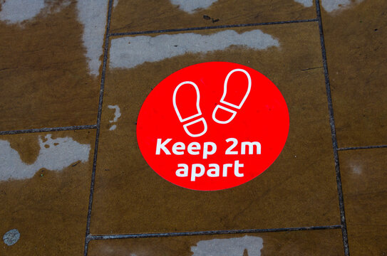 A Pavement Sticker Reminds Pedestrians To Keep 2m Apart