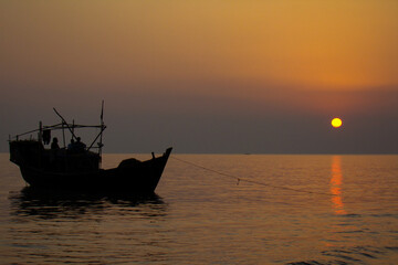 Fishermen are returning from sea with a fishing boat in the evening at Kuakata, Patuakhali, Bangladesh. 