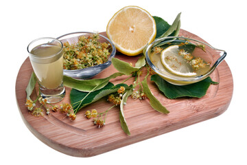 Fresh healthy linden flowers, lemon and tea with essential oil on a white background