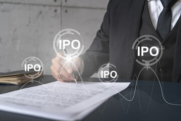 Businessman in suit signs paper. Double exposure with IPO icon hologram. Man signing contract agreement. Primary stock issue market analysis and investment concept.